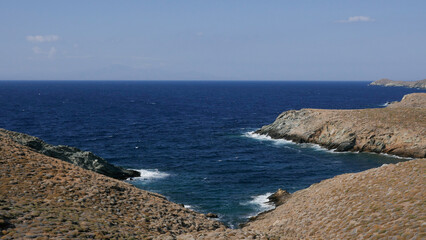 Rocky Coastal Inlet with Deep Blue Sea and Rugged Hills