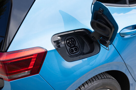 Fast charging socket type 2 combo electric car. DC - CCS type 2 EV charging connector at EV car. Type 2 CCS plug port on electric vehicle. Eco friendly alternative energy green environment concept.