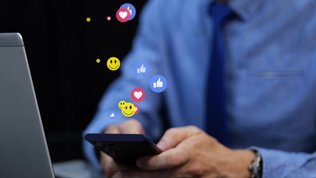 Businessman on social media. 3D emoji icons like heart and smile float over the phone. Graphic animation