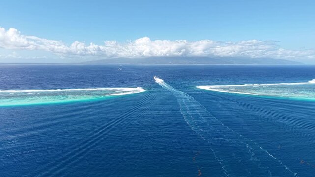 Moorea Island , French Polynesia. Drone Shot of Ferry Boat Leaving Lagoon in Coral Barrier Break