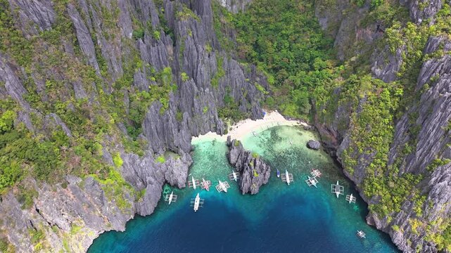 Stunning top view of boats at Secret Lagoon and Jiji's Beach, in Miniloc Island, Philippines