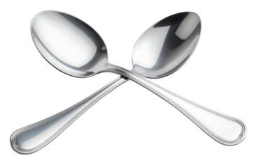 pile of two silver spoon in cross form isolated on white background