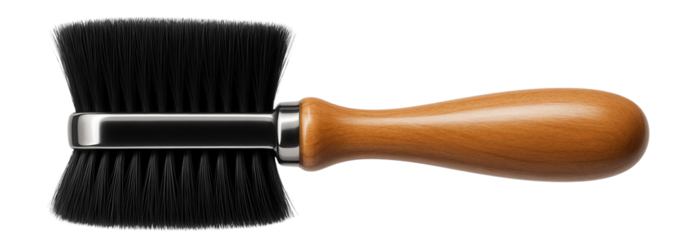 Soft-bristle brush with a wooden handle for dusting off carpentry tools in a workshop.