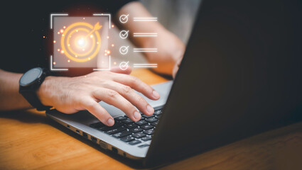 Business planning concept and strategic goal setting and with a businessman pointing at a target...