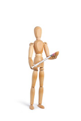 A wooden toy mannequin holding a syringe on white background