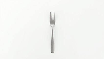 A metallic fork on a white surface.