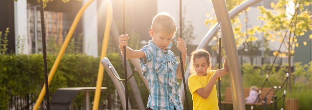 Happy little kids brother and sister on the playground