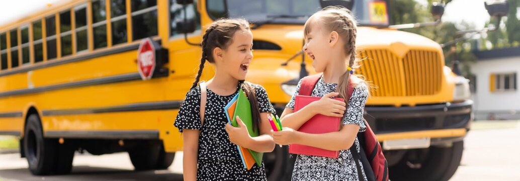 Little kids schoolchildren pupils students, the school bus. Welcome back to school. The new academic semester year start