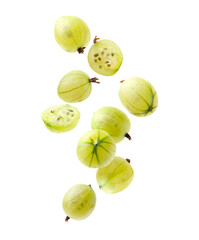 Fresh green gooseberries falling against white background