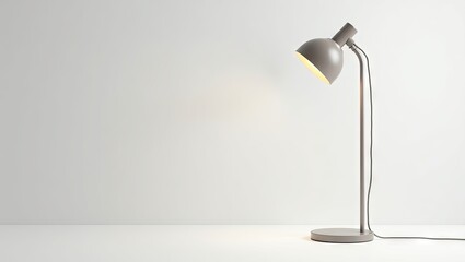 Gray desk lamp against a white wall.