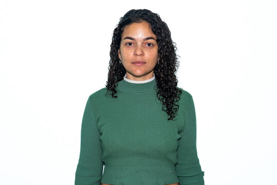Studio Passport-Style Portrait of Serious Latina Woman on White Background