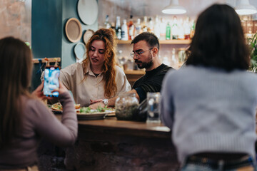 Warm and cozy atmosphere captures friends gathered at a stylish bar with food being prepared. A scene of social connection and culinary delight.