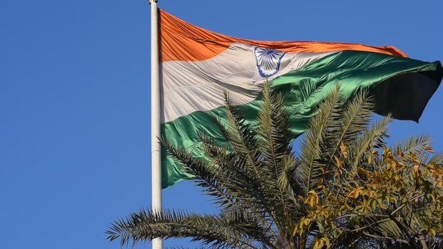 India flag flying high at Connaught Place with pride with plain white background, India flag fluttering, Indian Flag on Independence Day and Republic Day of India, tilt up shot, Har Ghar Tiranga