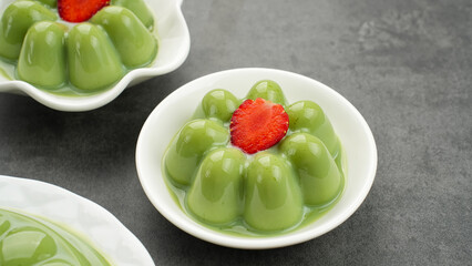 Matcha pudding dessert with strawberry topping
