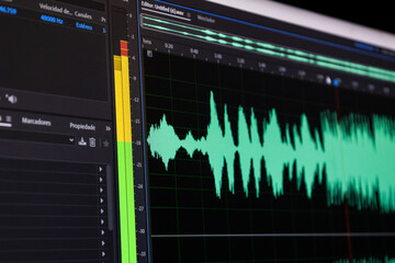 Creative workspace showing both color grading controls and sound waveform adjustments.

