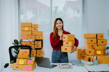 Portrait of Starting small businesses SME owners female entrepreneurs working on receipt box and check online orders to prepare to pack the boxes, sell to customers, sme business ideas online.