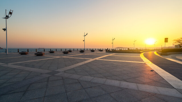 Sunset Over Empty Seaside Plaza with Clear Sky - Powered by Adobe