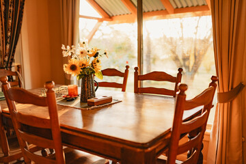 Blue jug filled with yellow sunflowers and white cosmos in rustic country kitchen