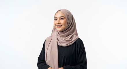 A smiling woman wearing a hijab and black top looking off to the side against a plain white background