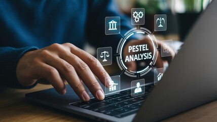 Business professional conducting a pestel analysis on a laptop