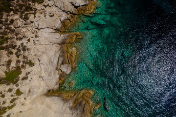 Aerial shot of a coastal landscape with clear blue waters.