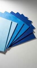 blue colored felt sheets fanned out on a solid white background