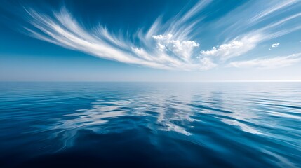 Obraz premium Serene expanse of a placid ocean beneath a vibrant sky.