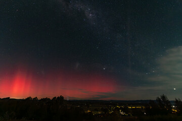 Beams of pink light caused by Aurora Australis in the night sky