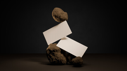 
floating minimalist business card mockup balanced on textured earth rocks in a dramatic studio scene