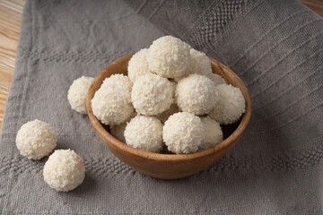 Coconut candies pile, coco ball. White truffle ball, indian ladoo or laddu with sweet cream and coco