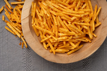 Fried chips sticks, finger potato chips, golden shoestring fries pile, French fries