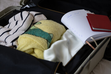 Checklist and Passports Inside Packed Suitcase