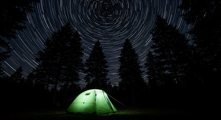 A glowing green tent in a dark forest under a spectacular night sky with circular star trails.