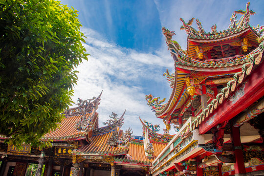 The view of Lungshan Temple in Taipei&rsquo;s Wanhua District (also known as Monga) features traditional Chinese architecture with intricately carved wooden beams, colorful. 