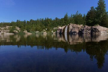 Small waterfall and its reflection in Katariina Seaside Park, Kotka, Finland