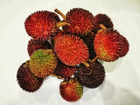 Close-Up View of Ripe Malaysian Pulasan Fruits on a White Background