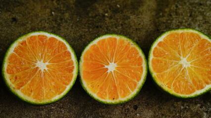 A halved mandarin orange with beautiful yellow flesh.