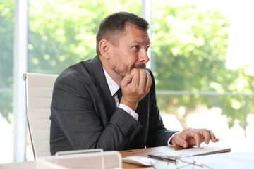 Naklejka premium Businessman suffering from panic attack at workplace in office