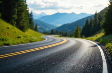 Fototapeta premium Winding mountain road surrounded by lush green trees and distant peaks under a partly cloudy sky