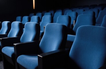 Fototapeta premium Empty blue theater seats arranged in a row with a dark background