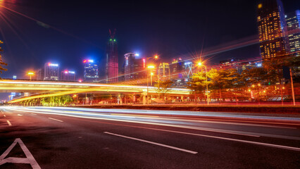 Night View of Urban Road with Light Trails and Skyscrapers