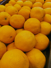 Tangerines fruits filled frame background. Vertical photo.