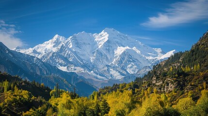 Fototapeta premium Snow-Capped Mountains Mirror in Clear Blue Sky and Lake: A Vivid Scene of Majestic Peaks Reflecting in Pristine Waters Under a Lively Azure Sky