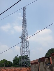 an internet network tower is seen towering high in a residential area