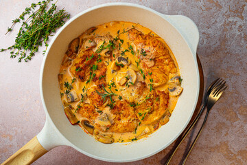 Fried chicken breast fillet in creamy mushroom sauce with champignons and oregano