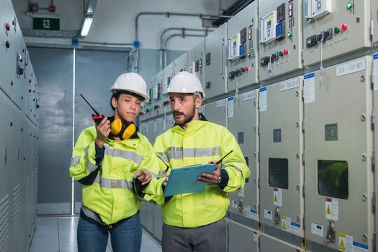 electrician working in a factory. electrician at work. electrician working in a power station. engineer working on the checking status switchgear electrical energy distribution substation.