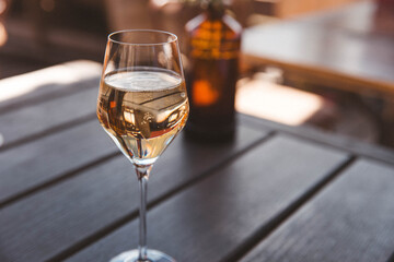 Chilled Champagne Glass on a Wooden Terrace Table in the Sun