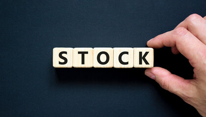Stock symbol. Concept word Stock on beautiful wooden blocks. Beautiful black table black background. Businessman hand. Business lifestyle stock concept. Copy space.