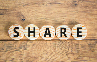Fototapeta premium Share symbol. Concept word Share on beautiful wooden circles. Beautiful wooden table wooden background. Business lifestyle share concept. Copy space.