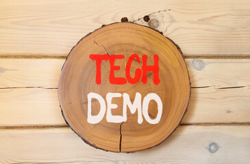 Tech demo symbol. Concept word Tech demo on beautiful wooden circle on wooden wall. Beautiful wooden wall background. Business tech demo concept. Copy space.